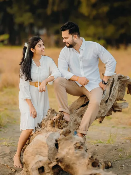 A classic pre-wedding portrait pose on a log. Milan and Pranali look relaxed and happy in this beautifully composed shot.