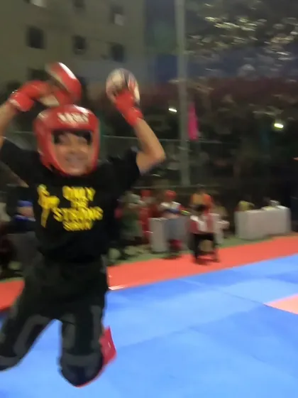Another shot of our young champion's victory celebration in the ring. This is what pure happiness and achievement look like.