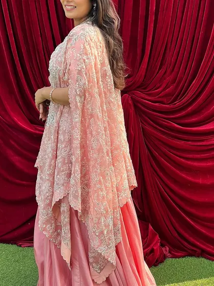 A side view of my pink cape set, showing the beautiful embroidery and the flowy silhouette. It’s one of my favorite outfits.