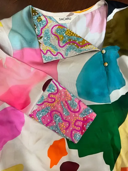A closer look at the vibrant and playful sequin embroidery on this unique, custom-designed blouse.