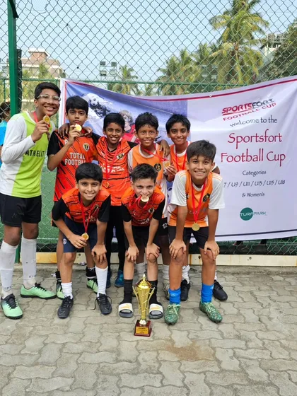 The victorious U13 team posing with their trophy and medals at the Sportfort Football Cup. A great performance and a well-deserved win.