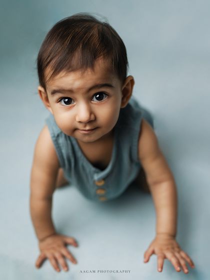 This little one is ready to explore. The crawling pose is a perfect way to document this active and exciting stage.