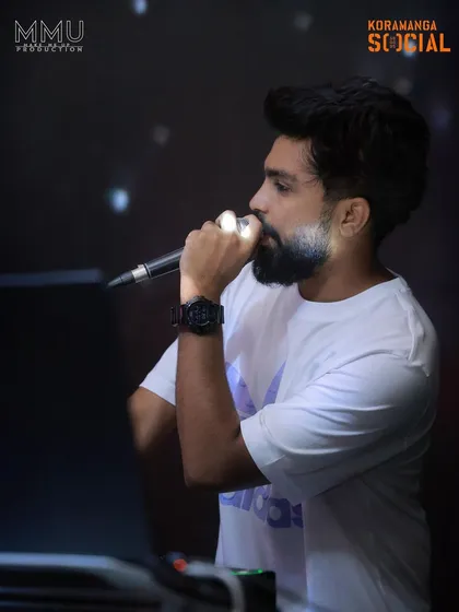 Another angle of me on the mic at Koramangala Social. I make sure my voice is heard, guiding the party's energy all night.