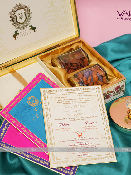 This stately invitation box features a custom family crest, exuding regal elegance. The interior is designed to hold both gourmet dry fruits and a complete set of vibrant, color-coded wedding ceremony cards.