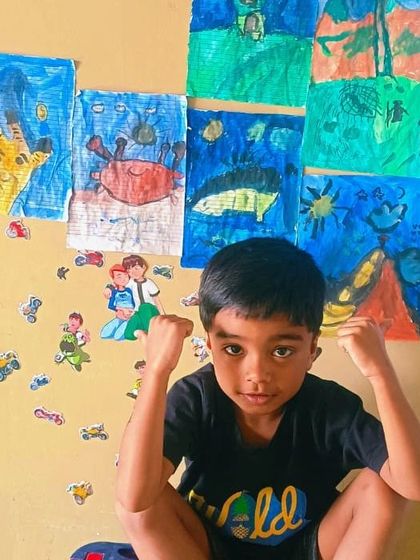 This young man is very proud of his collection of drawings, and he should be. Look at all that creativity.