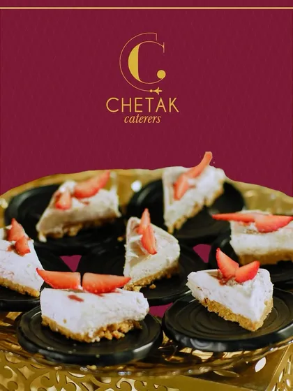 Mini strawberry cheesecake slices, elegantly presented on a platter. This classic dessert is always a favourite, offering a light, creamy, and fruity finish to a meal.