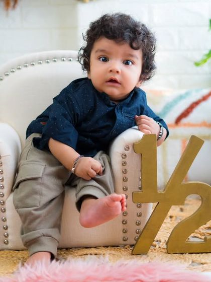 Half a year old and full of personality. This little guy's curious expression and relaxed pose are just adorable.