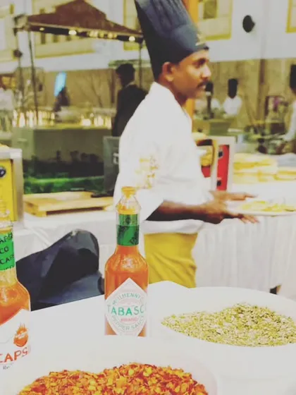 A look at our live pizza station, complete with all the essential seasonings like oregano, chili flakes, and Tabasco sauce for guests to customize their slices.