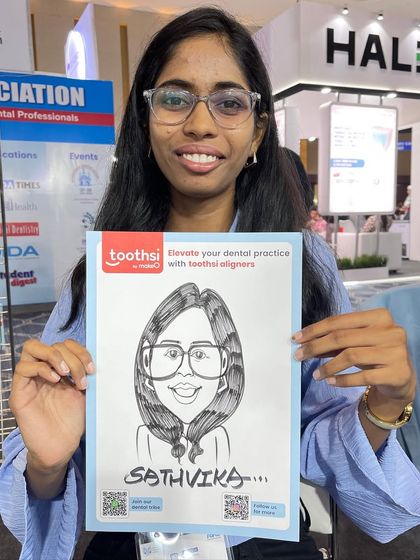 Another happy guest from the Toothsi dental event, holding her branded caricature.