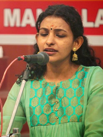 A student singing with deep feeling during the bhajan sandhya.
