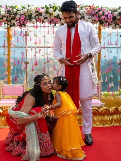 A heartwarming moment as a little one gives the bride a kiss during the haldi ceremony. Family moments like these are so special.
