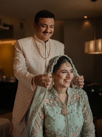 A father's blessing as he places the dupatta on his daughter's head. A moment filled with love, pride, and emotion that we are honored to capture.
