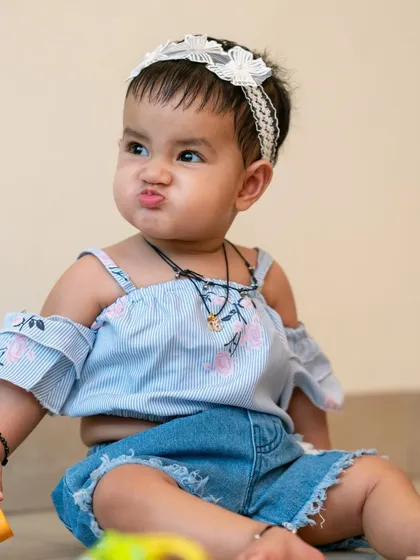 An adorable baby portrait, capturing a funny and cute expression. These are the candid moments that families cherish.