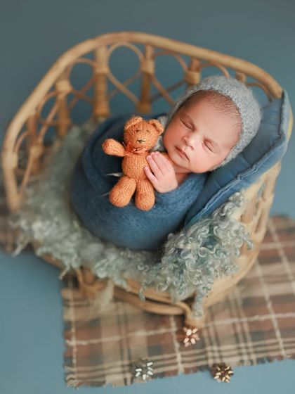 Something to brighten your Monday blues. This cozy setup in a rattan chair with a blue wrap and a tiny teddy is just too sweet.