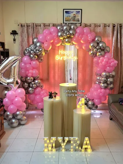 A pink and silver balloon arch for Myra's 4th birthday party at home.
