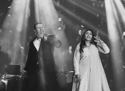 A black and white photo capturing a powerful moment between two performers on stage.
