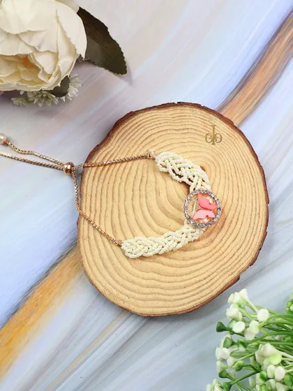 Another one of our adjustable butterfly Lumba Rakhis, shown here with a pink butterfly charm.