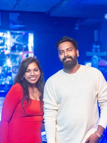 A couple enjoying the cool, blue-lit vibe of the pub.