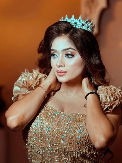 A beautiful portrait of the model in the golden gown, highlighting her makeup and the intricate details of the dress.