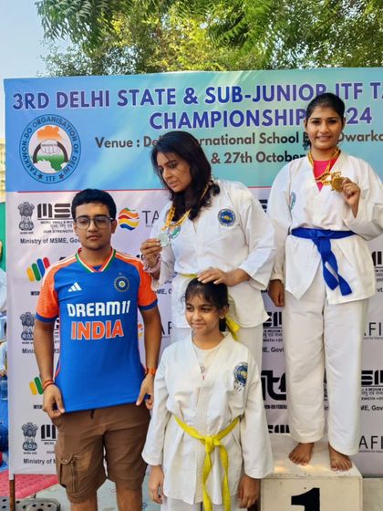 A family of athletes. A mother and her children celebrating their wins together on the podium.
