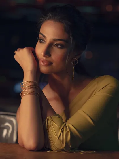 A beautiful, contemplative close-up from the yellow dress shoot. The soft lighting and thoughtful pose create an intimate and glamorous portrait.