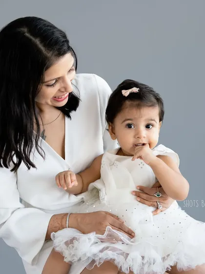 A beautiful, elegant portrait of a mother and her baby girl in matching white. These classic photos are a perfect way to celebrate Mother's Day.