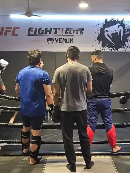 Focus is key during sparring. Here, I am observing our fighters in the ring, providing instruction and ensuring they are applying their techniques correctly and safely.