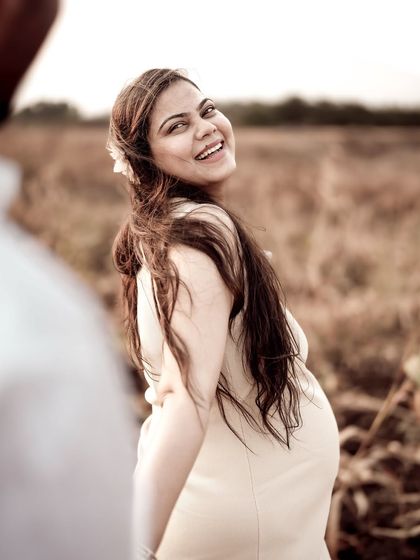 A beautiful "follow me" shot, with her looking back with a radiant smile. The warm, golden light of the field makes this photo glow.