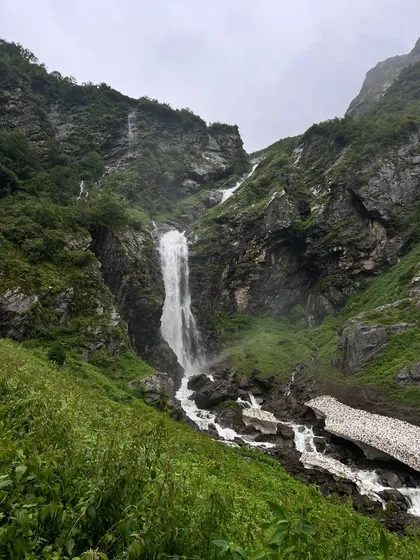 A powerful waterfall cascading down the rocky slopes on the trail to the Valley of Flowers. The journey is as beautiful as the destination itself.