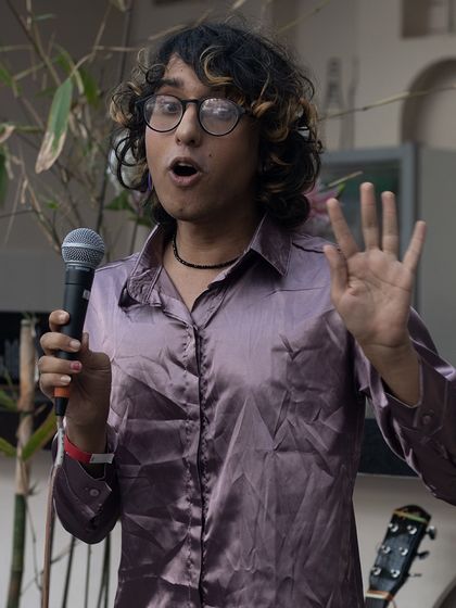An expressive performer captivating the audience during his open mic slot. It's not just about singing, it's about storytelling.