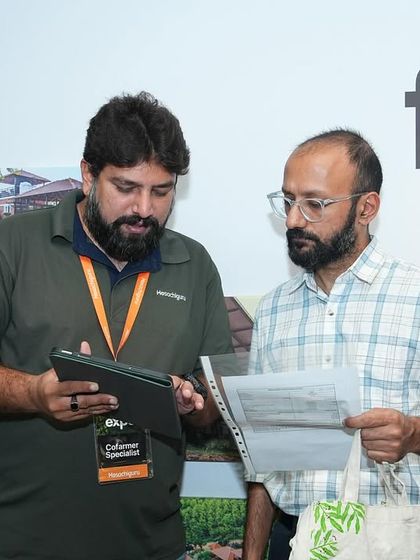 A member of our team walks a visitor through the details of a farm plot. We take the time to answer every question and ensure our co-farmers feel confident in their investment.
