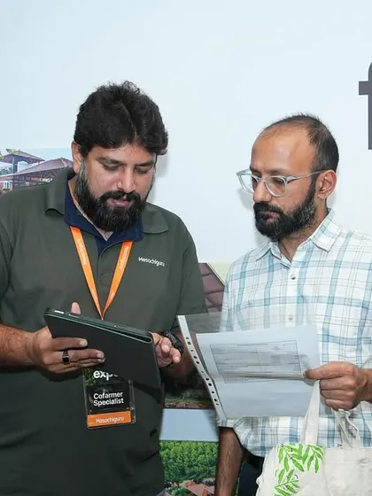 A member of our team walks a visitor through the details of a farm plot. We take the time to answer every question and ensure our co-farmers feel confident in their investment.