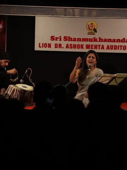 A wide shot of the stage and the audience in the foreground. It shows how our event filled the auditorium, with everyone engrossed in the soulful performance.