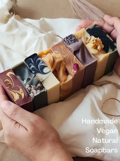 A beautiful lineup of my handmade, vegan, and natural soap bars. Each one is a unique work of art, showcasing different colors, swirls, and botanical toppings, all crafted with care.