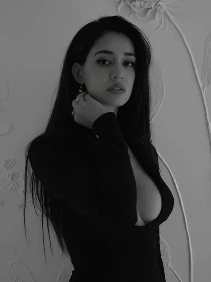 A direct and powerful gaze from Disha Patani. The clean hair and makeup ensure that nothing distracts from her expression in this striking black and white photo.