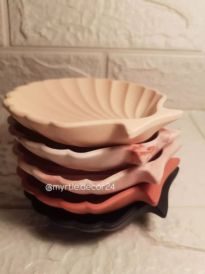 A stack of our mini shell dishes in various custom colors, showing the versatility of our handmade process.