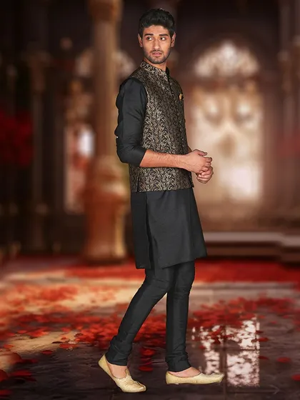 A black kurta with a gold and black brocade Nehru jacket, a luxurious and regal combination.