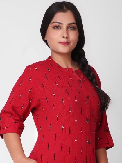 A medium close-up shot of the same model in the red kurti, focusing on the neckline and fabric pattern.