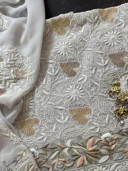 A flat-lay of the kurta and dupatta, styled with earrings.