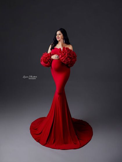 A joyful, confident pose in a stunning red gown. I love capturing these moments of pure happiness and self-love during a maternity session.