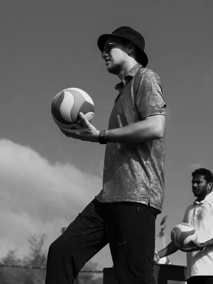 I hold a volleyball, captured in a timeless black and white frame. The ball is an extension of the player.