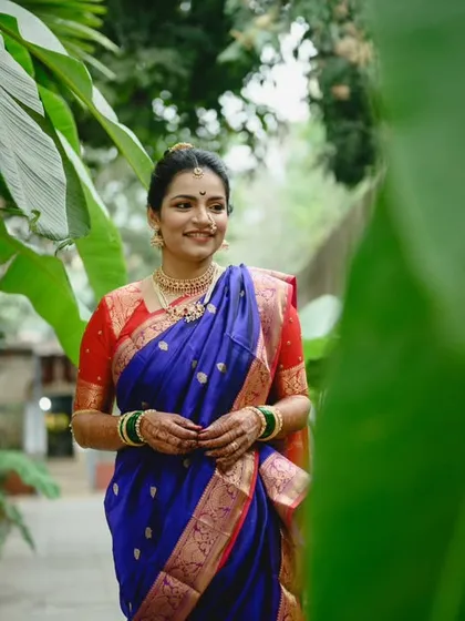 Another shot from Sanika's bridal portrait session. The lush green background makes the royal blue of her nauvari saree pop. She looks absolutely radiant.