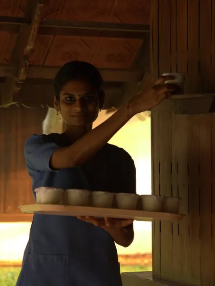 A therapist prepares a tray of herbal remedies for our guests. Each dose is carefully prepared according to our doctors' prescriptions, ensuring you receive the precise, natural medicine your body needs.