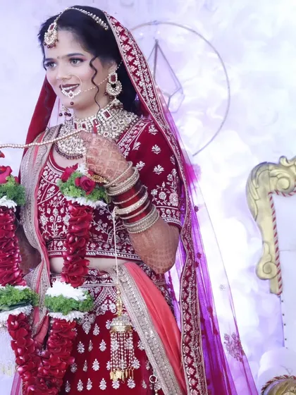 The bride holding her varmala garlands, ready for the ceremony. Her makeup is a perfect balance of tradition and modern glamour.