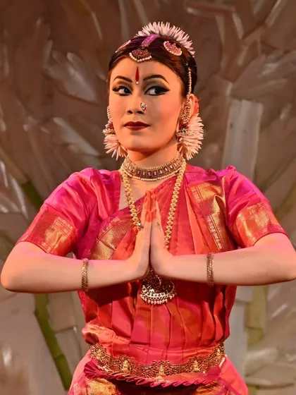 The traditional namaskaram pose, a gesture of respect to the stage, the guru, the musicians, and the audience. Stuti Mukherjee concludes a piece during her memorable arangetram.