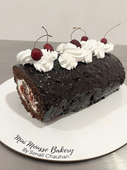 A side view of the Black Forest Swiss Roll, showing the perfect swirl of chocolate sponge and cream filling.
