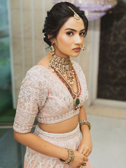 Twirl into a fairytale with this baby pink bridal lehenga. I designed it with intricate horse embroidery on the raw silk skirt and paired it with a heavily handworked blouse and a delicate net dupatta for a truly heavenly look.