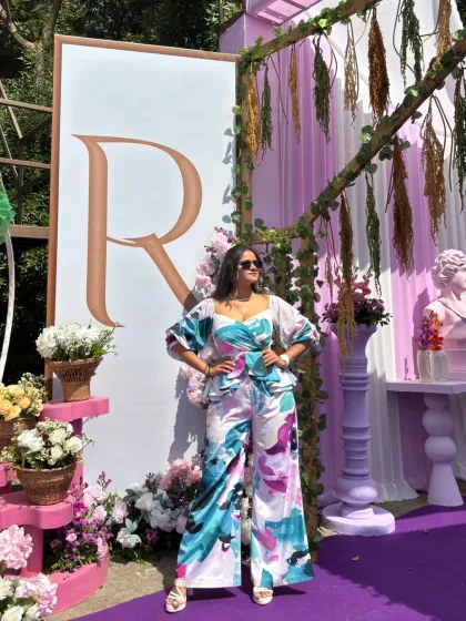 Standing proudly next to the couple's 'RR' monogram at their beautiful wedding carnival.