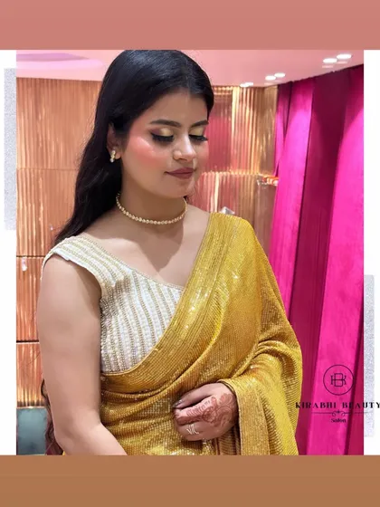 This client looks beautiful in her golden sequin saree. The makeup is kept warm with golden tones on the eyes to complement her outfit perfectly.
