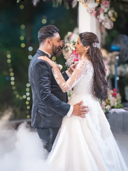 A close-up of the couple during their first dance. This shot captures their happy expressions and the beautiful details of the reception decor.